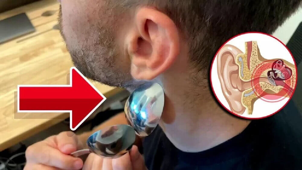 Person using a small metallic device near their ear, with an inset diagram of the inner ear structure